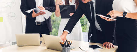 Group of professional business meeting and discussing strategy with new startup project on laptop computer.Creative business people management planning and brainstorm with document report in modern workloft.Teamwork conceptの写真素材