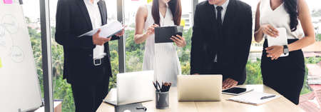Group of professional business meeting and discussing strategy with new startup project on laptop computer.Creative business people management planning and brainstorm with document report in modern workloft.Teamwork conceptの写真素材