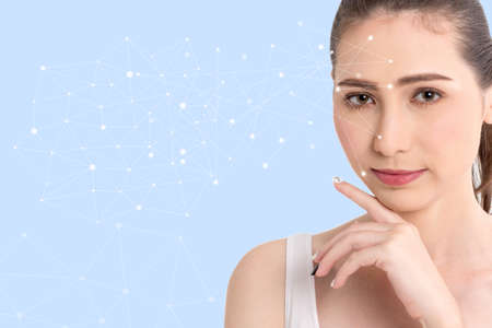 Beautiful woman beauty health care.beauty and spa with face tracking technology and science concept.perfect fresh skin isolated on blue backgroundの写真素材