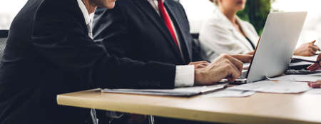 Group of professional business meeting and discussing strategy with new startup project on laptop computer.Creative business people management planning and brainstorm with document report in modern workloft.Teamwork conceptの写真素材