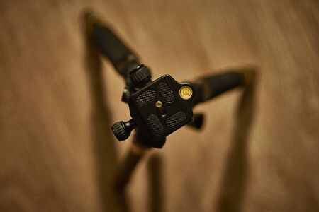 Tripod on the background of the laminate. Luxury tripod and laminate flooring.の写真素材