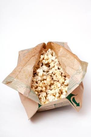 Popcorn in a paper bag on a white background.の写真素材