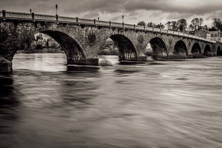 Water flowing under a bridge in Perthの写真素材