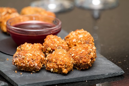 A shot of delicious deep fried haggis and a dipping sauce.の写真素材