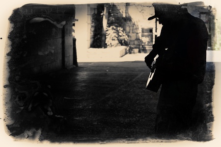 A Man playing guitar in an alleyの写真素材