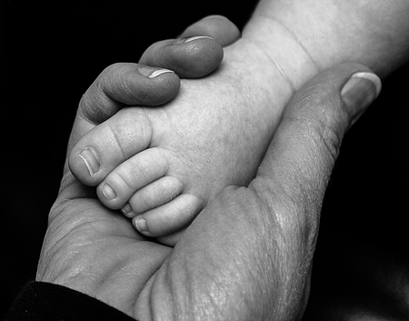 Shot of a mother holding son's foot