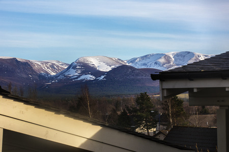 Distant snow capped mountings at sunsetの写真素材