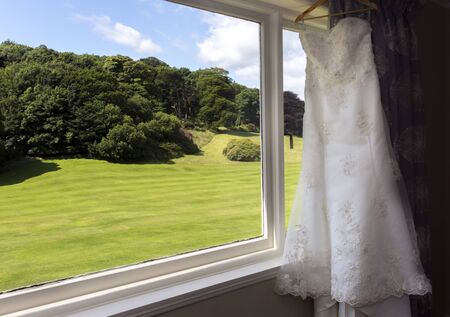Shot of a Wedding dress by a windowの写真素材
