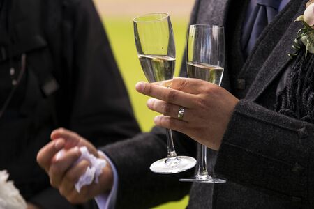 Shot of a man holding two champagne glassesの写真素材