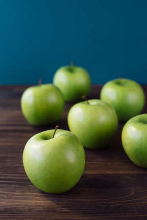 Group of green apples on brown wooden background. Close upの写真素材