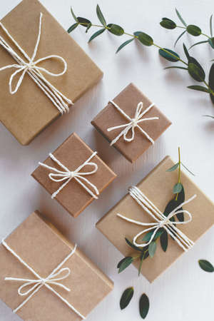 Craft gift boxes on white wooden background. Flat lay