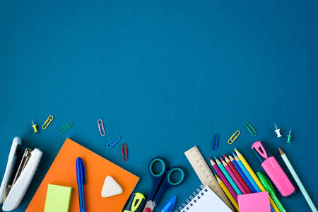 School supplies on blue background. Top view. Copy space.の写真素材
