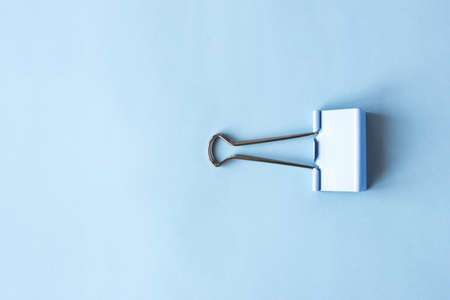 Blue clip on blue background. Top view.の写真素材