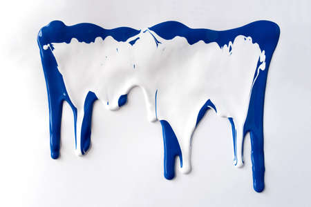 Blue and white paints leaking down white background. Close up.の写真素材