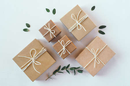 Craft gift boxes on white wooden background. Flat layの写真素材
