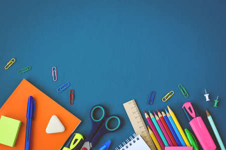 School supplies on blue background. Top view. Copy space.の写真素材