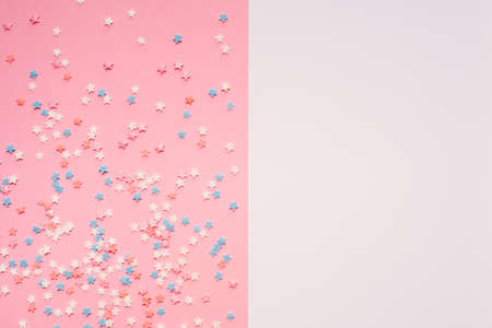 Little stars confetti on pink background. Holyday concept. Copy cpase for your text.の写真素材