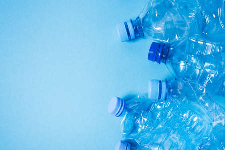 Crumpled plastic bottles of mineral water. Plastic waste background. Copy space for your text.