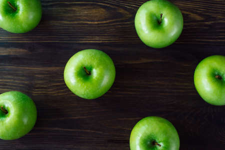 Fresh green apples on wooden background. Copy spase placeの写真素材