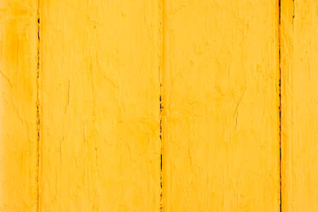 Yellow wood texture. Old wooden painted surface with flaky paint. Copy space backgroundの写真素材