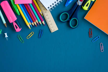 School supplies on blue background. Top view. Copy space.の写真素材