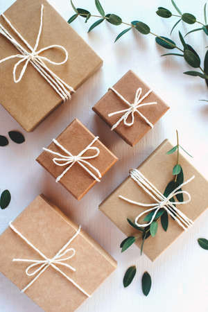 Craft gift boxes on white wooden background. Flat layの写真素材
