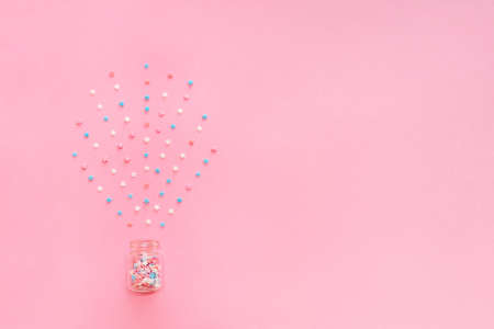 Little stars confetti on pink background. Holyday concept. Copy cpase for your text.の写真素材