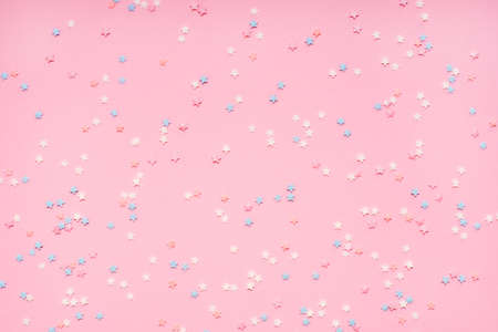 Little stars confetti on pink background. Holyday concept.の写真素材