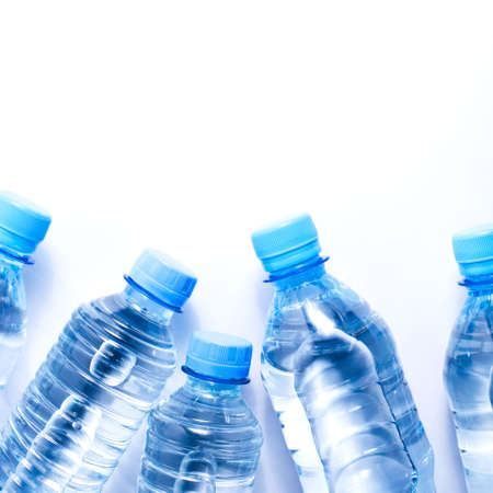 Several drinking water bottles on white background. Eco concept. Copy space for your text.の写真素材