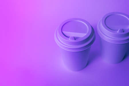 Paper disposable cups in trendy neon light.の写真素材