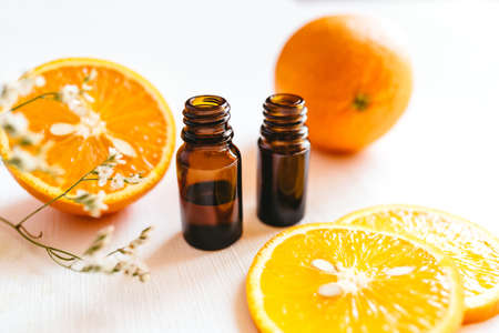 Two bottle of orange essential oil on white background for beauty, skin care, wellness and medicinal purposes.の写真素材