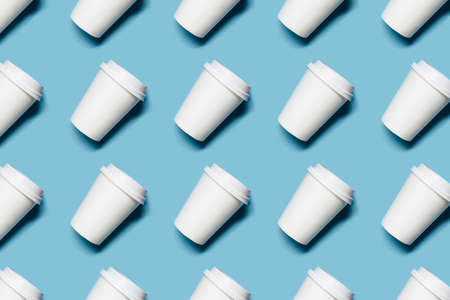 Pattern with lot of paper cups for coffee or tea on blue background.の写真素材