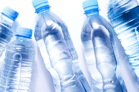 Several plastic water bottles on white background. The concept of plastic free patternの写真素材