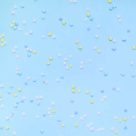 Little stars confetti on blue background. Holyday concept.の写真素材