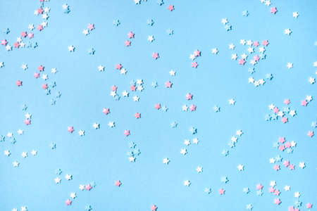Little stars confetti on blue background. Holiday concept.の写真素材