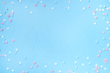 Little stars confetti on blue background. Holiday concept. Copy space for your text.の写真素材