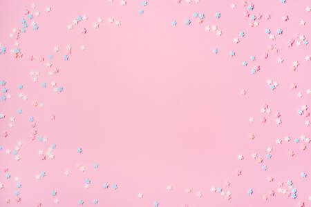 Little stars confetti on pink background. Holiday concept. Copy space for your text.の写真素材