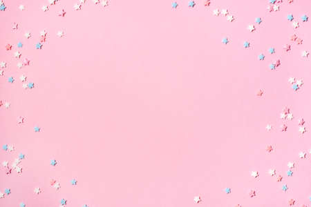 Little stars confetti on pink background. Holiday concept. Copy space for your text.の写真素材