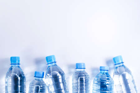 Several plastic water bottles on white background. The concept of plastic free.の写真素材