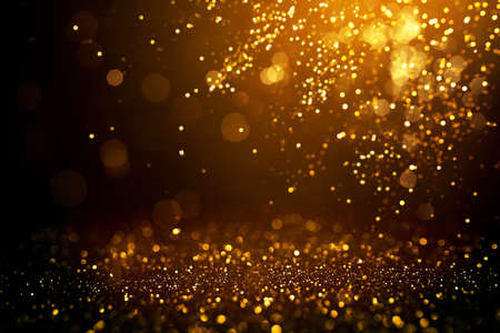 Golden abstract bokeh on black background. Holiday conceptの写真素材