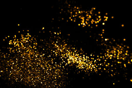 Golden abstract bokeh on black background. Holiday conceptの写真素材