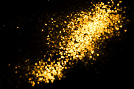 Golden abstract bokeh on black background. Holiday conceptの写真素材