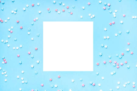 Little stars confetti on blue background. Holiday concept. Copy space for your text.の写真素材
