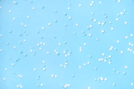 Little stars confetti on blue background. Holiday concept.の写真素材
