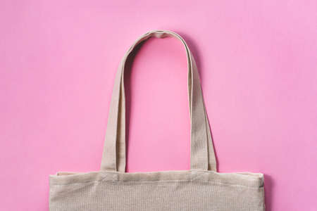 Fabric eco-bag on pink background. Flat lay, close up.の写真素材