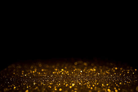 Golden abstract bokeh on black background. Holiday conceptの写真素材