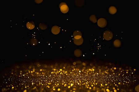 Golden abstract bokeh on black background. Holiday conceptの写真素材