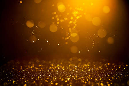 Golden abstract bokeh on black background. Holiday conceptの写真素材