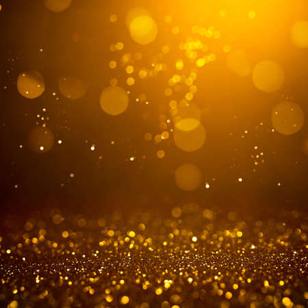 Golden abstract bokeh on black background. Holiday conceptの写真素材