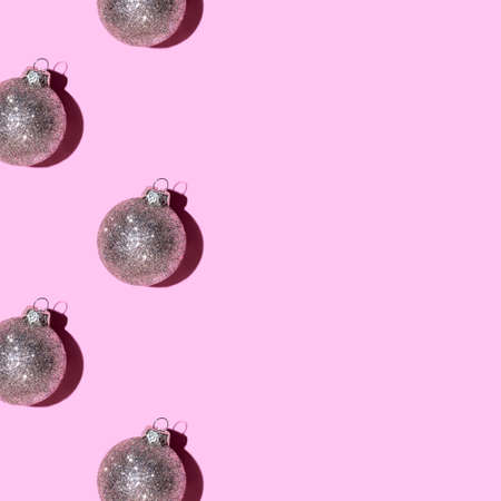 Pattern made of silver balls on pink background. Christmas or New Year concept. Flat lay. Copy space.の写真素材